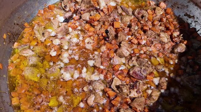 Large pot with traditional hungarian dish beef soup bograch, street food, background