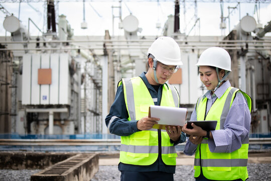 Engineers inspect electrical substation equipment during power grid maintenance, supporting safety, utility infrastructure reliability, and high voltage operations planning.