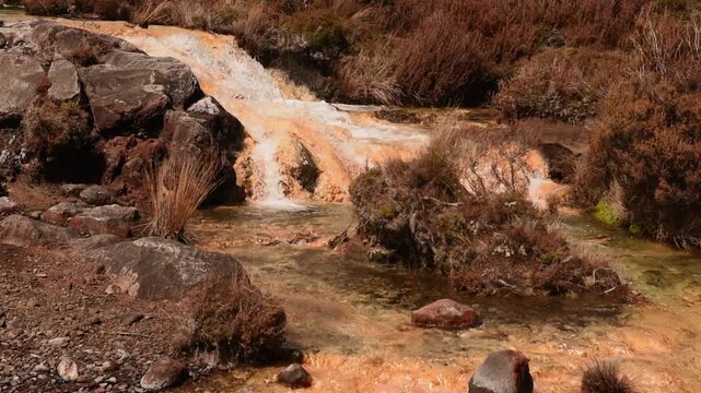 Silica Rapid terraces on the slopes of volcanic Mount Ruapehu, Tongariro National Park New Zealand. Creamy white aluminium and silicate minerals dissolved in the water are deposited on the stream bed.