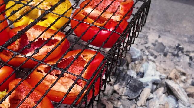Grilling halves of red and yellow bell peppers, street food, background