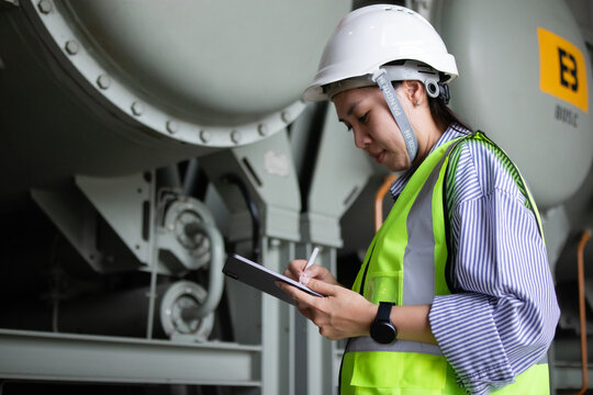 Electrical engineer documenting transformer inspection at substation, auditing auxiliary equipment for maintenance diagnostics, safety compliance, and asset reliability.