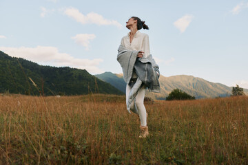 Fototapeta premium A young woman runner moves across a golden field in the countryside, wind in her hair, basking in freedom and a carefree outdoor moment.