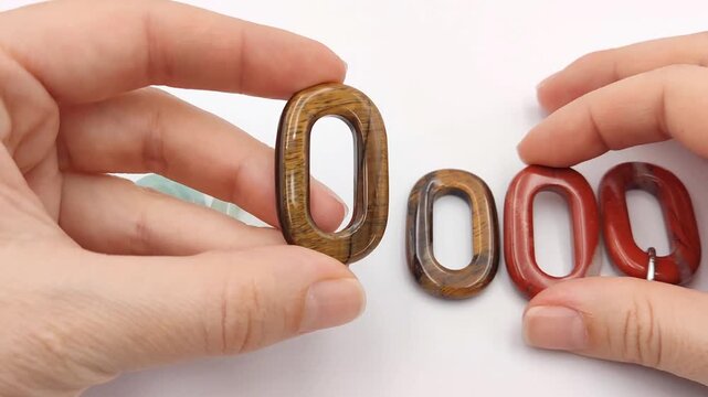 Polished oval gemstone links including tigers eye, jasper, and jade are showcased side by side on a clean white background, highlighting their natural smooth textures for artisan jewelry supplies