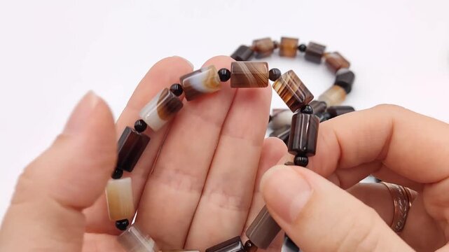 A close inspection reveals the unique striped patterns and earthy tones of natural botswana agate beads crafted into stylish stretch bracelets for modern jewelry collectors