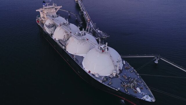 Aerial of Liquified Natural Gas LNG carrier moored to a small gas terminal. Fuel crisis. Sanctions