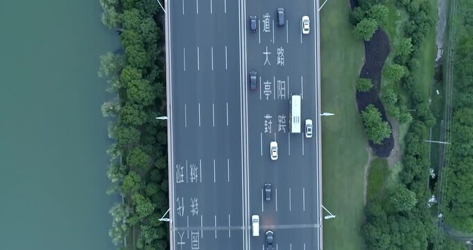 Aerial drone flight over evening road traffic. Two-level road junction. Top view. 4K
