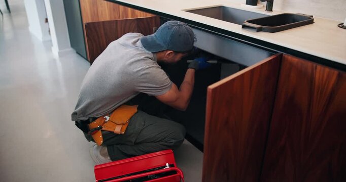 Fixing, sink and man with tools in kitchen, drainage system maintenance and plumbing skills in house. Handyman, home repair and pipe improvement with equipment, installation and leak prevention