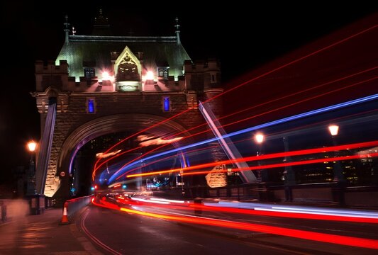 London, UK - Circa September, 2018: Night light trails at the Tower Bridge. Taken with slow shutter.