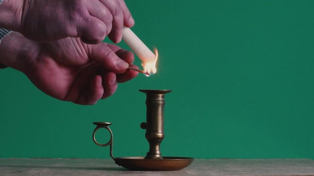 Instal ad lighting a candle with a flame in a simple setup indoors
