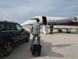Middle Eastern business team boarding private jet for executive travel at desert airport © .shock