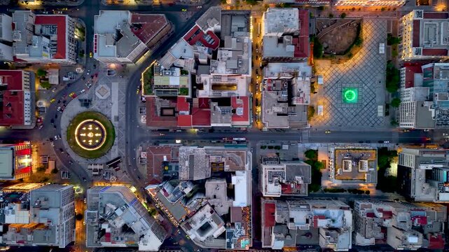Aerial overhead view of the illuminated downtown skyline of Athens, Greece, with Omonia and Kotzia Square during dusk