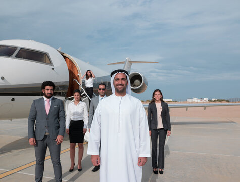 Middle Eastern business team disembarking private jet showing corporate leadership and luxury travel