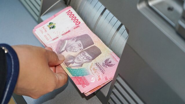 Indonesian rupiah banknotes counted through modern cash machine