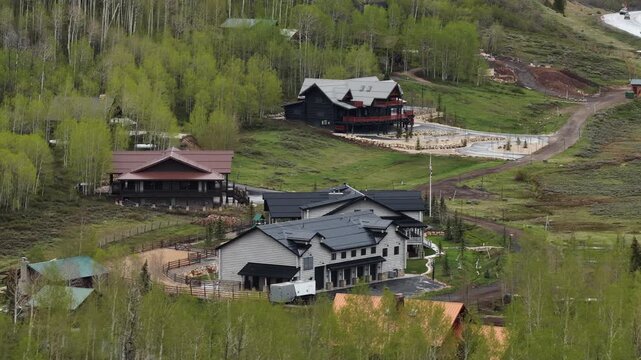 Aerial of luxury mountain homes on Daniels Pass in Utah Uinta National Forest in spring