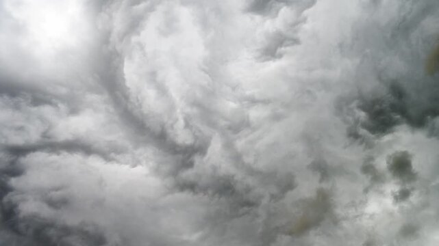 Grey thunderstorm clouds rolling overhead in an ominous weather sky scene