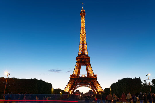 Paris, France-May 14, 2026 : A stunning full frontal view of the Eiffel Tower in full golden illumination at blue hour, perfectly centered against a deep cobalt sky.