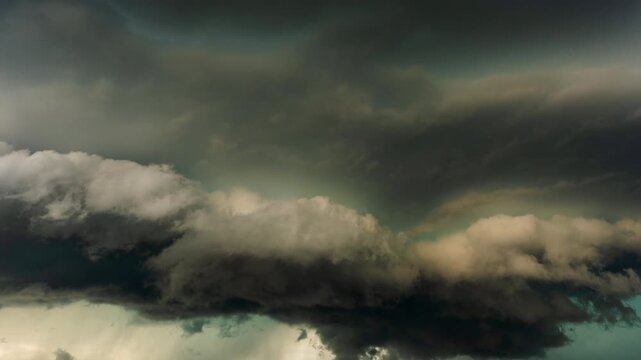 Heavy storm cloud layers shifting through a dramatic overcast sky scene