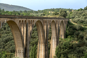 Fototapeta premium The grandiose viaduct on the doorstep of Guadalupe , Spain crossing the rugged valley of the Guadalupejo. At 274 metres long and 58 metres high it was one of the largest bridges in Spain.