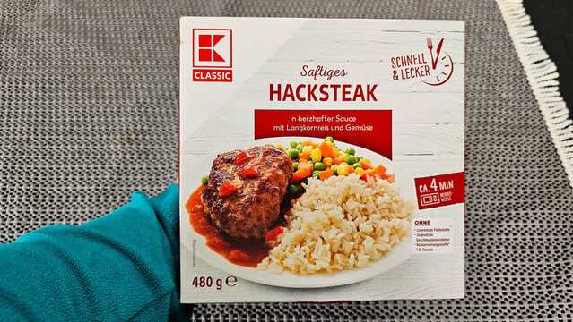 Hand holding k classic ready meal box with hacksteak