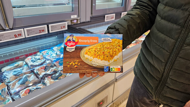 Person holding iglo frozen fish fillet in supermarket