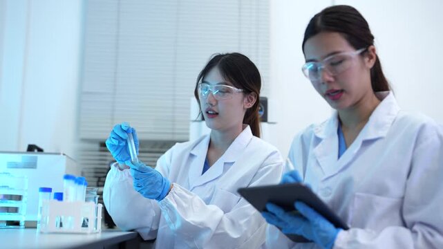 Team of biochemical research scientists using microscopes for vaccine development in a pharmaceutical laboratory, medical research and healthcare innovation.