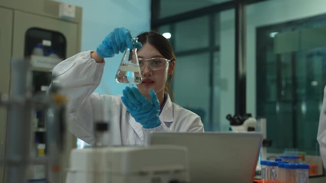 Team of biochemical research scientists using microscopes for vaccine development in a pharmaceutical laboratory, medical research and healthcare innovation.