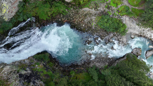 Majestic river flows through lush greenery, showcasing nature's vibrant beauty in a serene landscape
