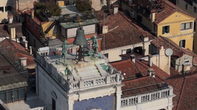 Aerial View of Historic Bell and Rooftop Statues in Sunlight