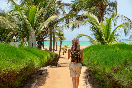 Young Woman with braided hair walking at beach of Grand Popo in Benin - West Africa