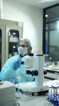 Environmental scientist testing water quality sample for microplastics and chemical contaminants in laboratory.