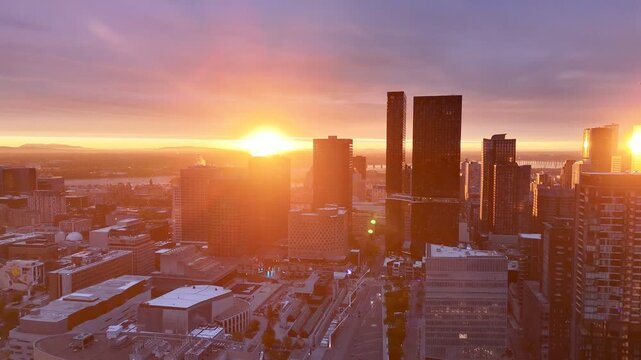 Vibrant sunrise over Montreal skyline with St Lawrence River and La Grande Roue reflecting colorful evening sky. g.