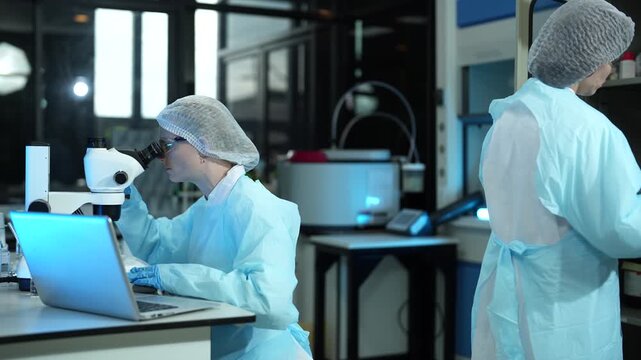Environmental scientist testing water quality sample for microplastics and chemical contaminants in laboratory.