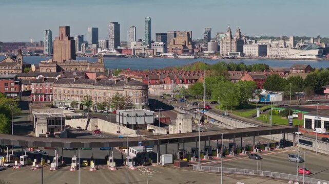 Cityscape shows Queensway Mersey Tunnel toll booths with Liverpool skyline beyond, Birkenhead