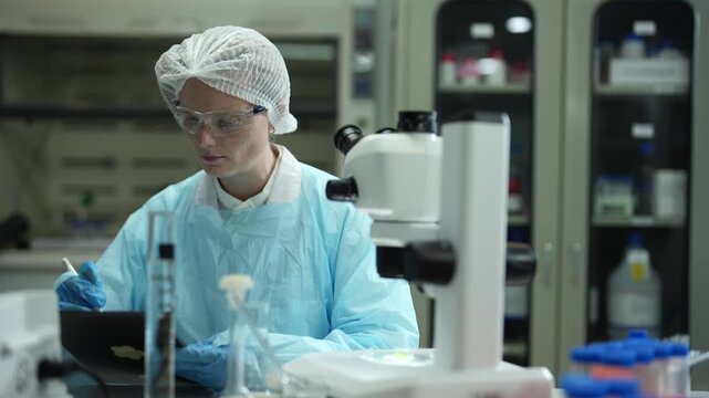 Environmental scientist testing water quality sample for microplastics and chemical contaminants in laboratory.