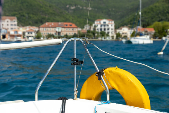 A view of the city, on the seashore, from the bow of a small yacht