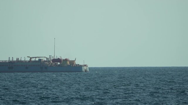 Dredger, ocean, sea large industrial dredger ship sailing on blue water under clear sky