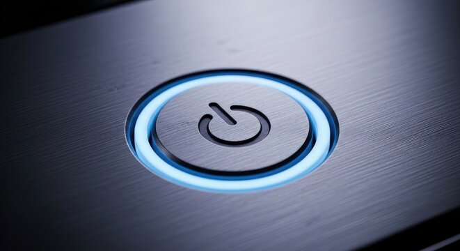 Illuminated Power Button on Metallic Surface.