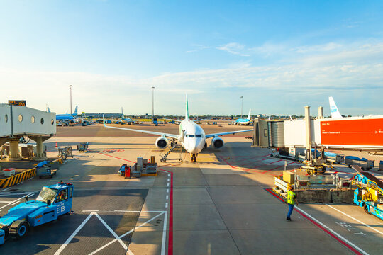 Amsterdam, Netherlands - 22.01.2026: Commercial passenger airplane parked at airport terminal gate and ground support equipment at amsterdam airport