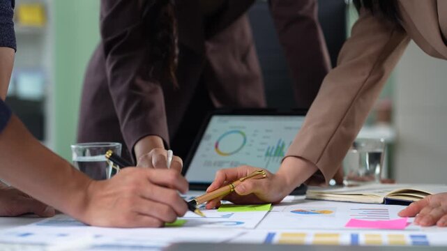 Businessman collaborate on project analysis with financial graphs. Strategic teamwork and insights drive company growth and success.