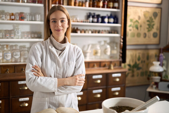 Happy young female chemist working in laboratory.