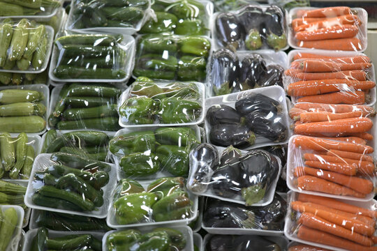 Fresh vegetables wrapped in plastic at market
