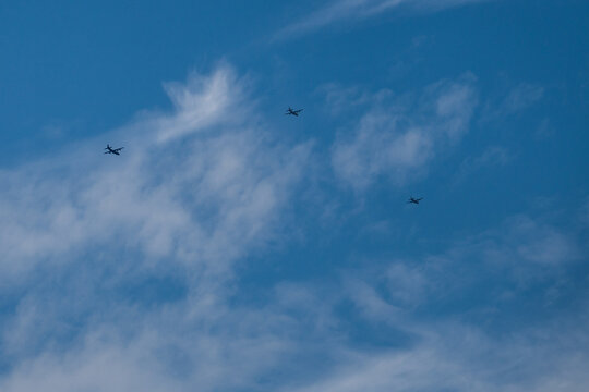 Three military planes flying in blue sky