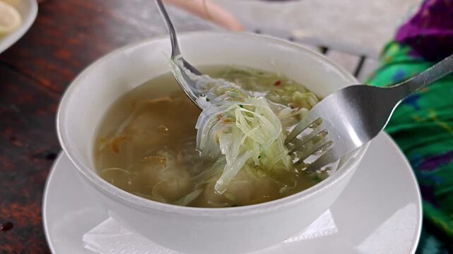 Indonesian Bakso Meatball Soup Served with Glass Noodles and Cabbage in Bowl