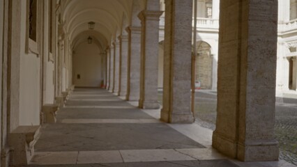 Blurred colonnade corridor with soft bokeh focus and warm stone tones under vaulted arches  background backdrop copyspace. © Krakenimages.com