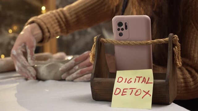 technology and hobbies concept. digital detox words and woman potter making clay bowl. Selective focus.