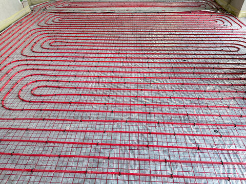 Installation of underfloor heating system in building, above view