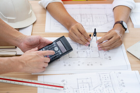 Calculating project costs construction planning office setting work documentation professional environment collaborative viewpoint