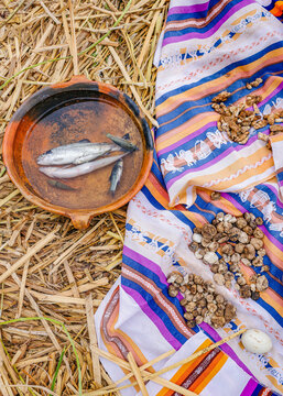 Puno, Peru - 29 Nov, 2025:  Fresh fish and corn dry in the sun on the Uros Islands, Lake Titicaca, Peru
