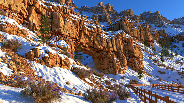 Snow-covered rocky hillside with a natural stone archway and pathway, national par