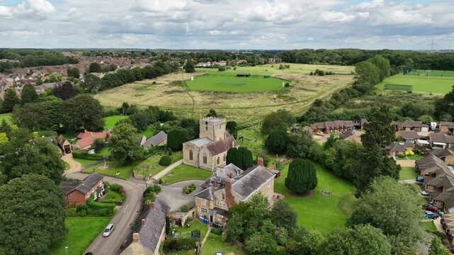 Aerial Drone View of Barton Seagrave Village Church and Green English Countryside in Northamptonshire